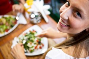 Woman eating with company